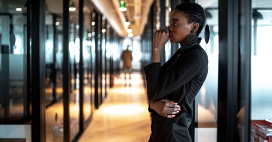 Sad African-American businesswoman alone in her workplace